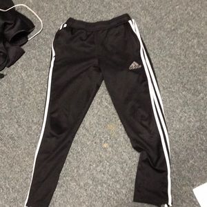 Adidas track pants with zippers on the calf.
